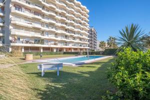 a swimming pool in front of a large apartment building at Las Antillas, Carvajal in Fuengirola