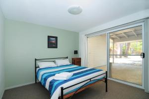 A bed or beds in a room at Jervis Bay Waterfront