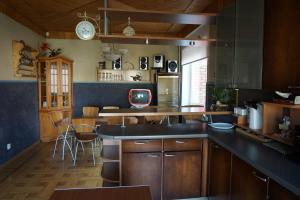 a kitchen with wooden cabinets and a counter top at Home for Guests Lakštingala in Šiauliai