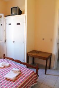 a bedroom with a bed and a table with a tv on top at Edificio Casa Alba in La Paloma