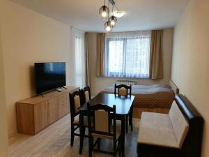 A television and/or entertainment centre at Borovets Gardens Apartment A27