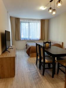 A television and/or entertainment centre at Borovets Gardens Apartment A27