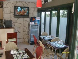 a dining room with tables and chairs and a television at Times Apart in Çeşme