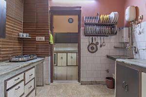 a large kitchen with a counter and a doorway at Garden Cottages in Shimla