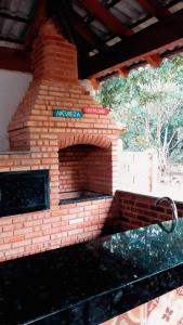a brick fireplace with a street sign on it at Pousada Alto Caparaó in Alto Caparao