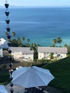 a white umbrella and a view of the ocean at Amazing views!! in Santa Bárbara de Samaná