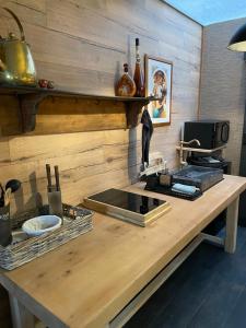 a kitchen with a wooden counter top with a stove at Cosy Central House with luxury jacuzzi bath in Hesdin