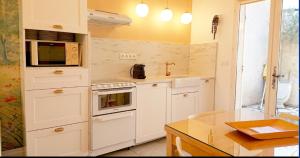 a kitchen with white appliances and a counter top at clos coutin in Gréoux-les-Bains