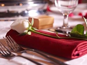a table with a red napkin with a flower on it at Premiera Hotel Kuala Lumpur in Kuala Lumpur +24 photos
