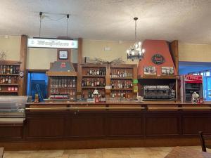 a bar in a restaurant with a counter top at Hotel Le Polle in Riolunato