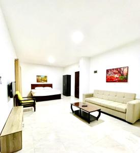 a living room filled with furniture and a couch at Faraseen Apartments in Al Qasţal