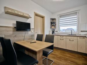 a kitchen with a wooden table and chairs in a kitchen at Gäste- und Ferienwohnung in der Sportstadt Riesa in Riesa +6 photos