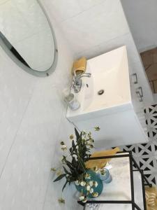 a bathroom with a sink and a mirror at One bedroom Apt 30 steps from prime beach generator parking included in San Juan
