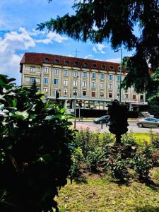 a large tan building with a red roof at HOTEL MUNTENIA in Campina