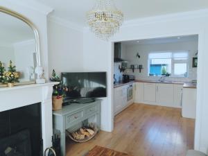 a living room with a fireplace and a television at Castlebar 3 bedroom house in Castlebar