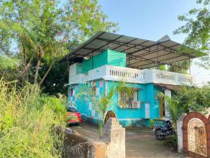 a blue house with a motorcycle parked in front of it at Sukh Villas - Best Budget villa in Karjat in Karjat