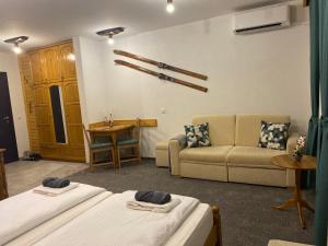 a living room with two beds and a couch at Luxury private studio in Paradiso Verde in Bansko +36 photos