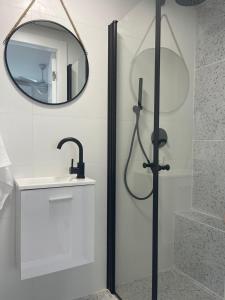 a bathroom with a shower and a mirror at Emanuel Suite in Eilat