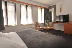 Letto o letti in una camera di Hôtel du Perron