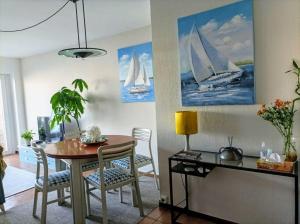 a dining room with a table and sailboats on the wall at Vista Azul in Baiona