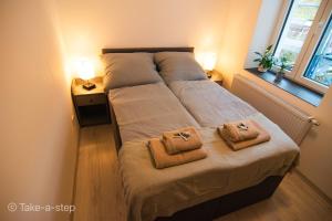 a bed with two towels on it in a bedroom at Qonroom - as individual as you - Dillenburg in Dillenburg