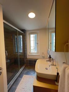 a bathroom with a sink and a shower at Sea Canal Townhouse in Göcek