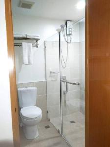 a bathroom with a toilet and a glass shower at Persimmon Studios - Studio Unit- 16th Floor - 1641 in Cebu City