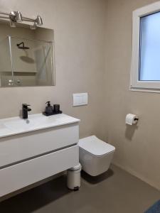 a white bathroom with a sink and a toilet at Altea city center in Altea
