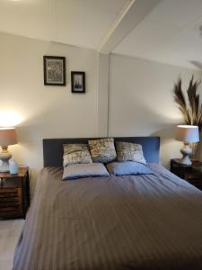 a bedroom with a large bed with two pillows at 2 -3 persoons chalet in bosrijk park Kempenbos-Duc de Brabant in Diessen