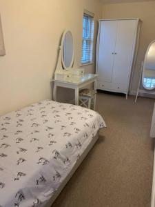 a bedroom with a bed and a desk and a mirror at 2 Bedroom duplex apartment in Bawtry