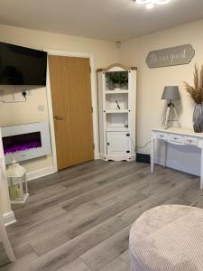 a room with a wooden floor and a door at 2 Bedroom duplex apartment in Bawtry