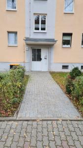 a brick driveway in front of a house at Exclusivwohnung Hohenmölsen in Hohenmölsen