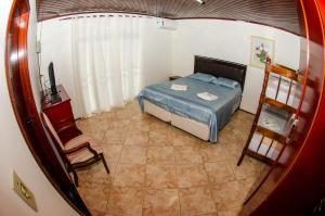 Postel nebo postele na pokoji v ubytování Suítes Recanto das Orquídeas + 8 fotografií