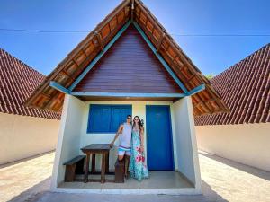 a man and a woman standing in front of a house at Tijota Hotel Fazenda in Ipatinga