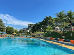 a large pool with blue water in a resort at Tijota Hotel Fazenda in Ipatinga