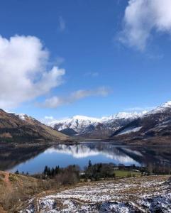 a view of a lake with snow covered mountains at Duirinish Pods with Private Hot Tubs and Duirinish Bothy with No Hot Tub in Plockton