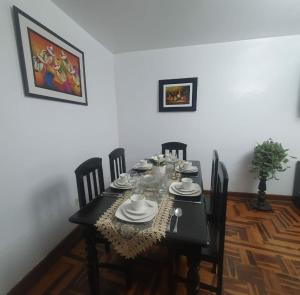 a dining room with a table with chairs and a tableablish at Depa Céntrico, cerca a todo! in Cajamarca