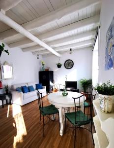 a living room with a white table and chairs at Charming Portuguese style apartment, for rent "Vida à Portuguesa", "Amêndoa or Limão" Alojamento Local in Portimão