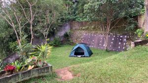 a blue tent sitting in a yard next to a fence at Villa Kay Mountain in Bogor +18 photos