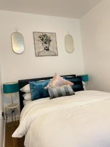 a bedroom with a bed with two mirrors on the wall at CityNights Studios with Free Parking in Liverpool