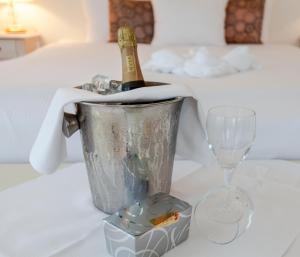 a bucket with a bottle of champagne and glasses on a table at Hotel Schimmelpenninck Huys in Groningen