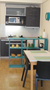 a kitchen with a blue counter and a table at Carlos Gardel Tango Studio in Buenos Aires