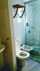 a bathroom with a toilet and a shower and a sink at Carlos Gardel Tango Studio in Buenos Aires