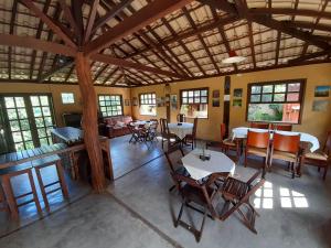 an overhead view of a living room with tables and chairs at Pousada Refazenda - Milho Verde in Milho Verde