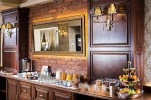 a kitchen with a counter and a brick wall at Aventinus Hotel in Nyíregyháza +22 photos