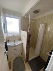 a bathroom with a sink and a shower and a window at Beautiful Holiday Home in Tootgarook/Rye in Tootgarook