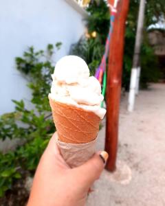 a person is holding an ice cream cone at Hotel Casa Lima Bacalar in Bacalar