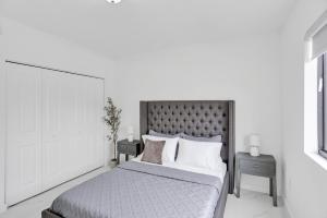 a bedroom with a large bed with two night stands at Renzzi Wynwood Apartments in Miami