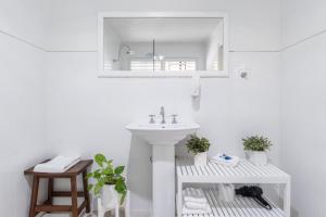 a white bathroom with a sink and a mirror at Debbie's Place in Rainbow Beach +46 photos
