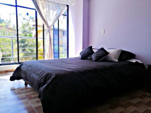 Ένα ή περισσότερα κρεβάτια σε δωμάτιο στο Living Robayo Paipa